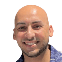 A man smiling at the camera against a white background.